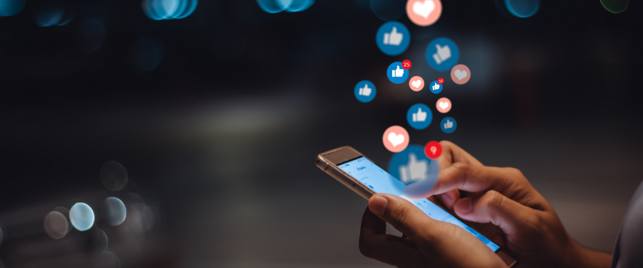 person with phone surrounded by social media icons