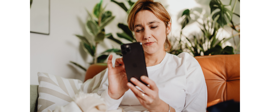 Woman on couch looking at phone
