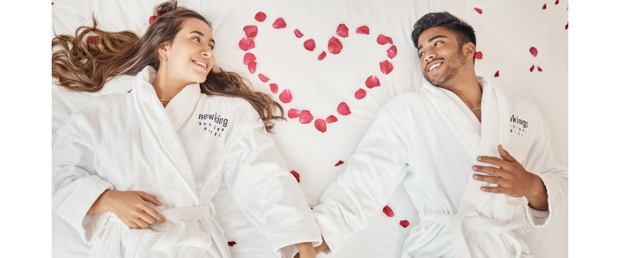 valentines day salon and spa promotion ideas - a couple in spa robes surrounded by roses