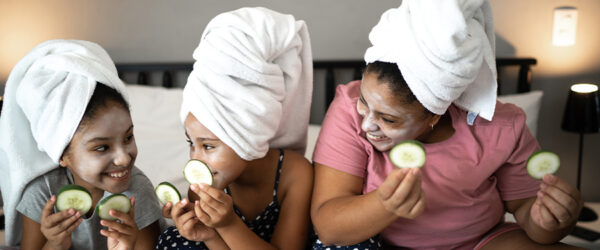 A mother and two daughters doing spa activities together