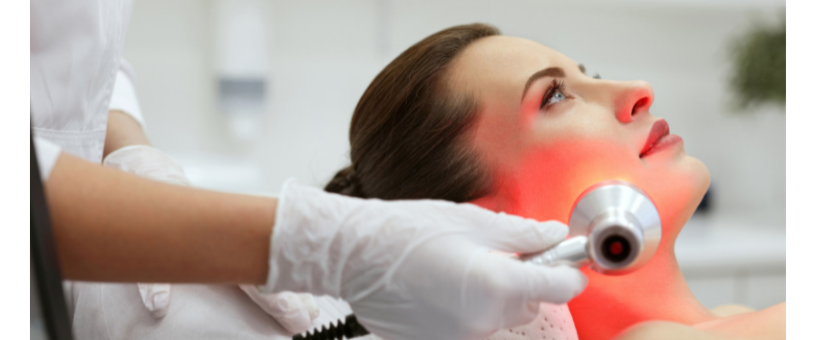 A woman getting laser therapy at a med spa