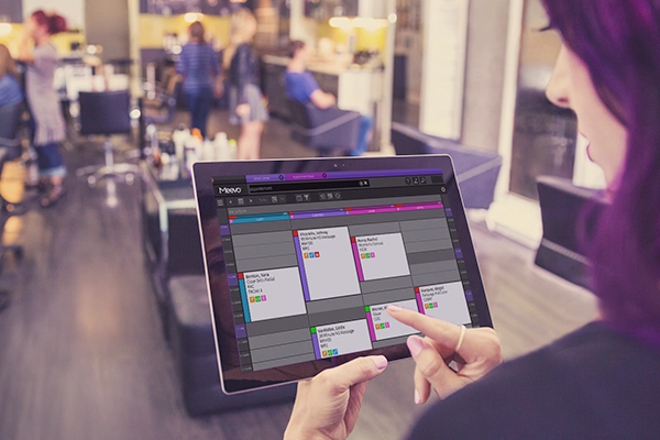 women on tablet reviewing Meevo appointment book
