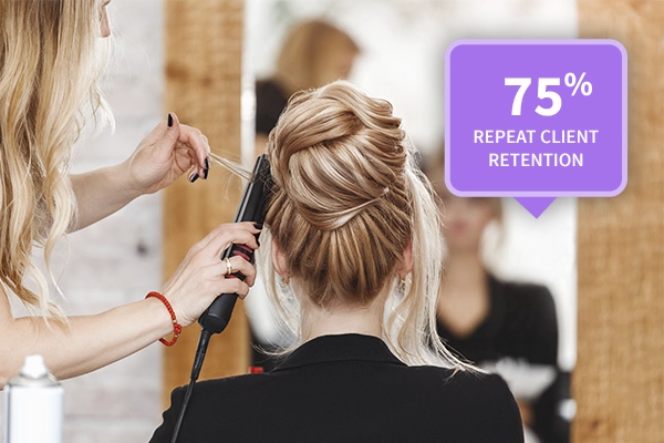 75% Repeat Client Retention - Salon stylist curling client hair