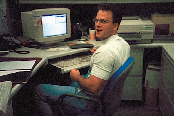 John Harms sitting at his desk at work
