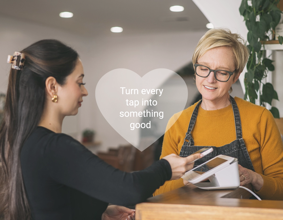 Female client making a donation at checkout with her phone - Turn every tap into something good